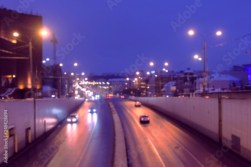 Six-lane road in the city at night, view from the bridge.