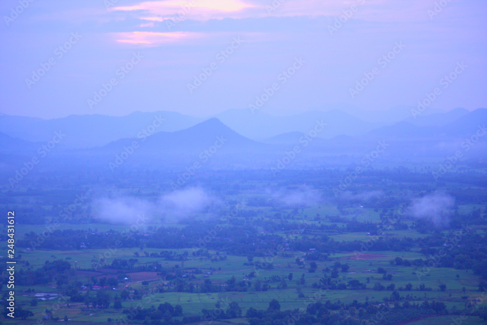 Fototapeta premium Beautiful sunrise and the mist on highland with mountain in Thailand