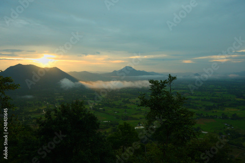 Beautiful sunrise and the mist on highland with mountain in Thailand
