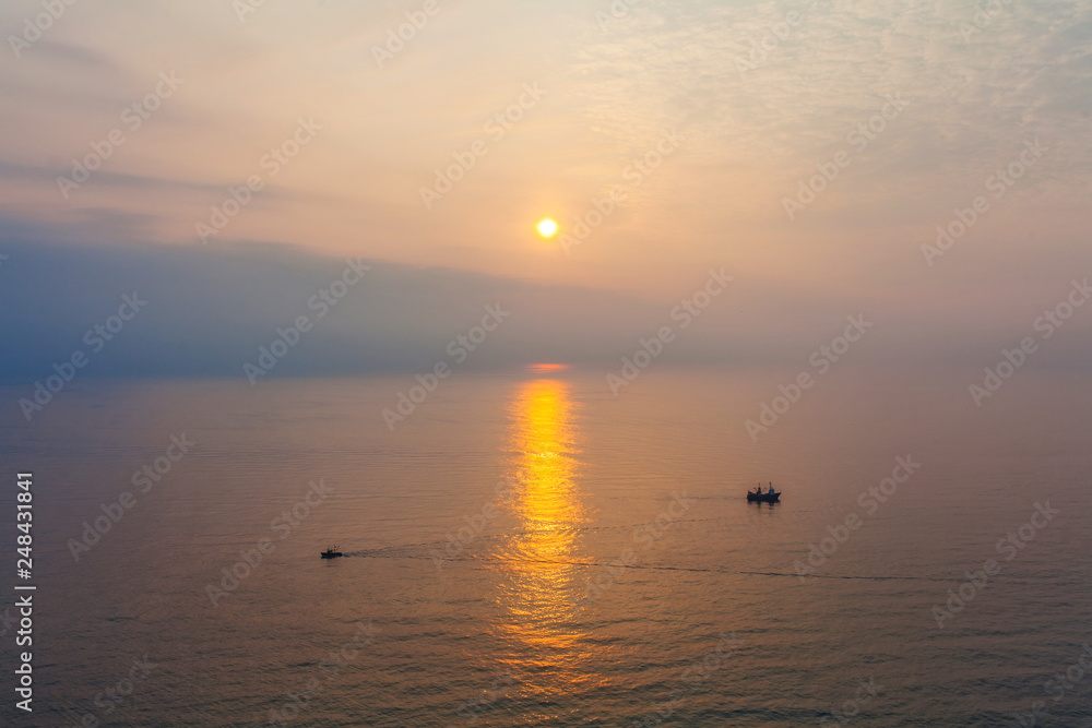 Two boats in the sea at sunset time