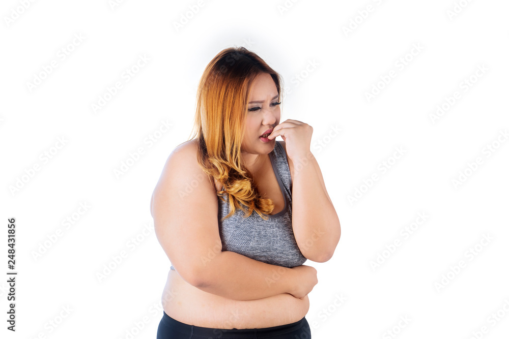 Caucasian fat woman biting her fingernails Caucasian fat woman biting her fingernails