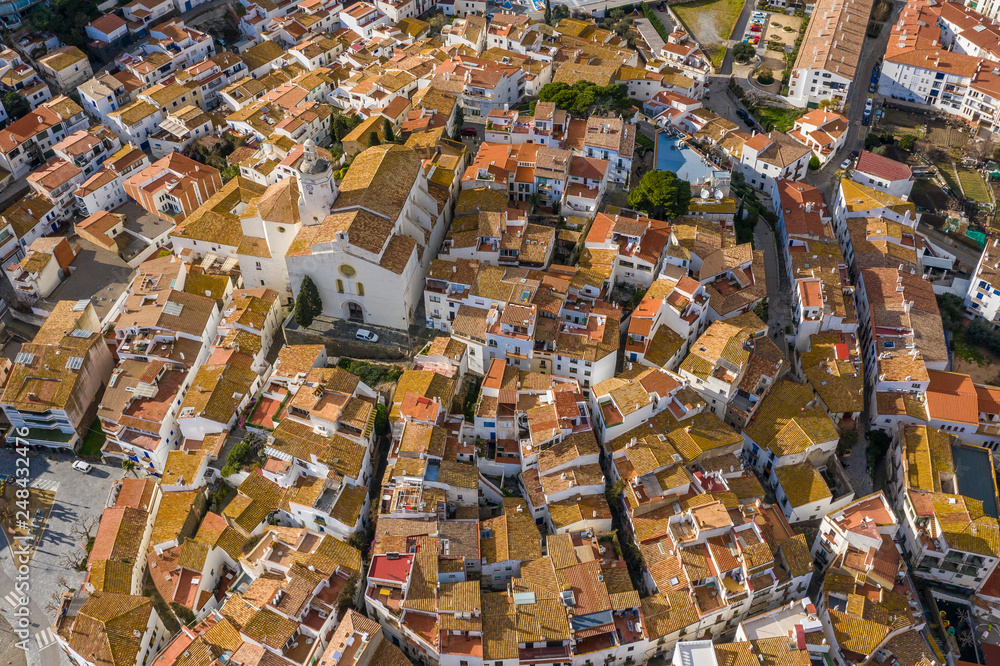 Aerial view of tiled roofs of Cadaques Spain. View from above. Sunny day in Spain. Drone photo