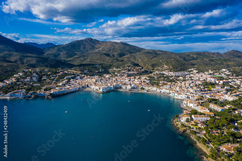 Fototapeta Naklejka Na Ścianę i Meble -  Aerial panoramic view of city Cadaques, sea and mountains, Beautiful Spanish small city by the sea. Drone photo of cityscape