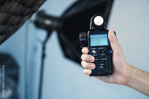 Hand held light meter isolated in studio lights