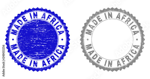 Grunge MADE IN AFRICA stamp seals isolated on a white background. Rosette seals with grunge texture in blue and grey colors. Vector rubber watermark of MADE IN AFRICA caption inside round rosette.
