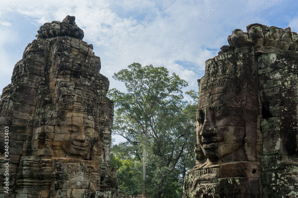 The beautiful stone faces of the ancient temple of Bayon inside the Angkor Thom complex in Cambodia