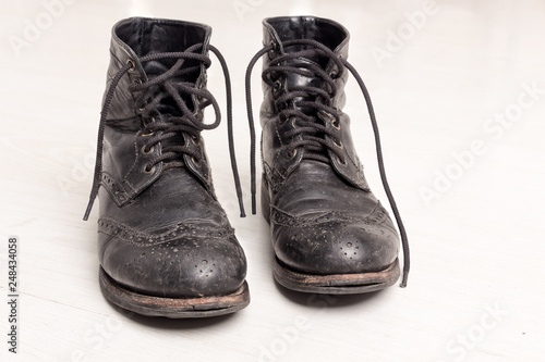 Pair of old leather black hipster boots