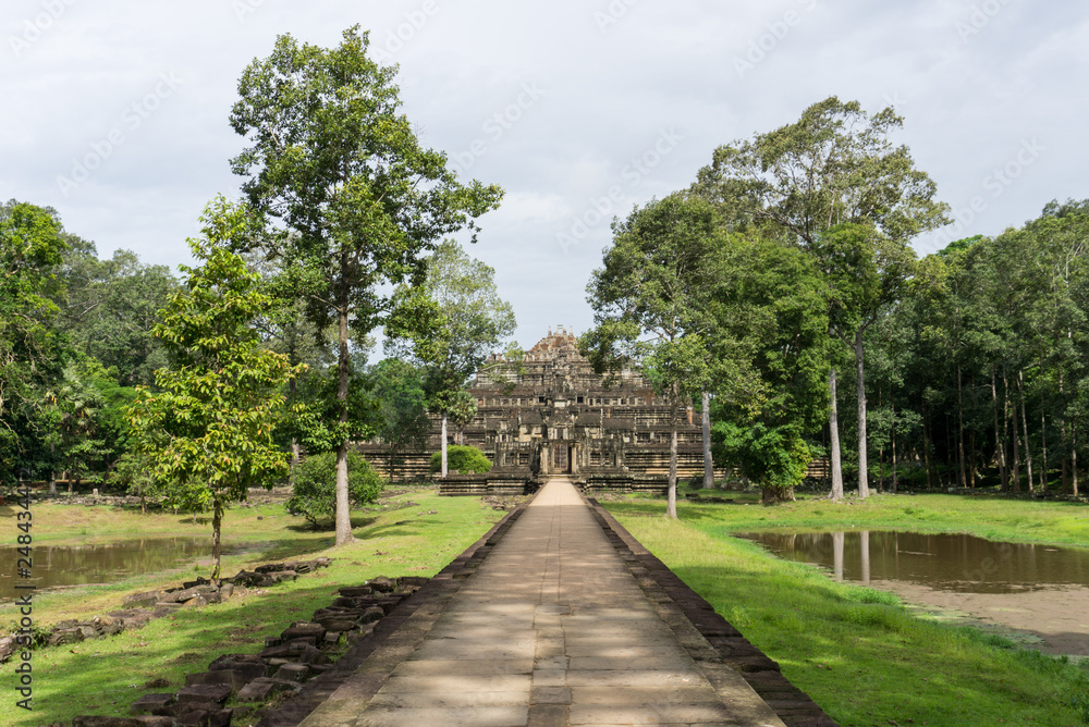 Path leading to a temple at Angkor archaeological site Path leading to a temple at Angkor archaeological site