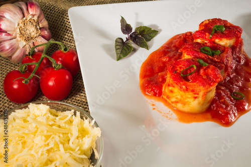 Traditional Italian Rondelli pasta with tomato sauceon rustic background photo