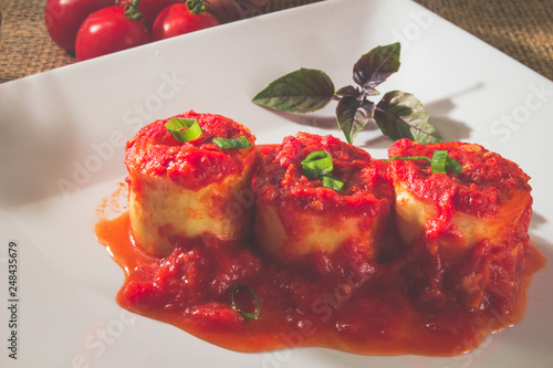 Traditional Italian Rondelli pasta with tomato sauceon rustic background photo