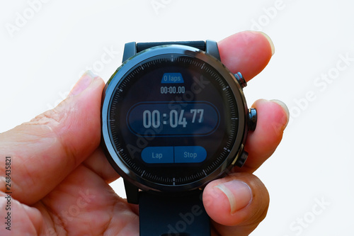 Close up digital stop watch in the hand on white background use for sport concept and technology background