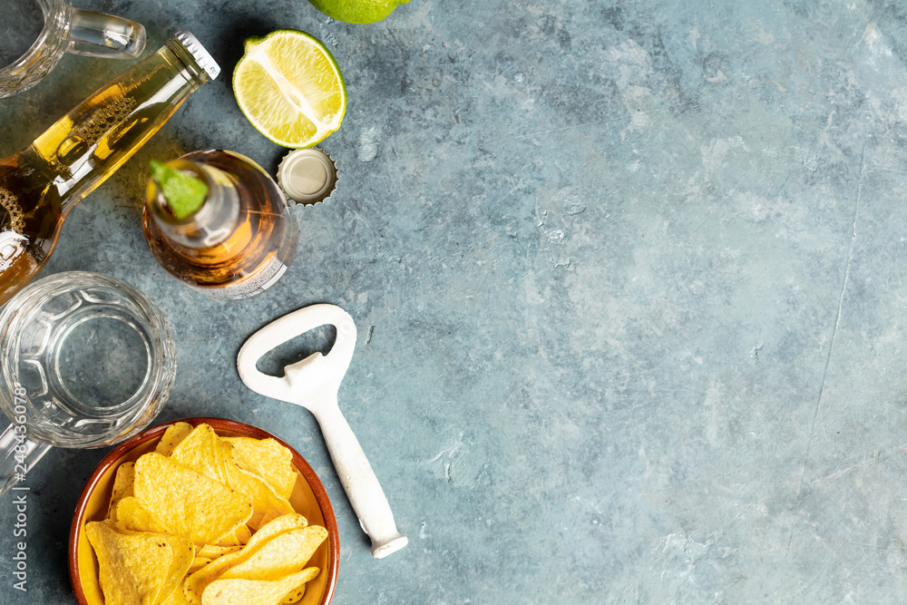 Nachos and beer on blue background, flat lay Nachos and beer on blue background, flat lay
