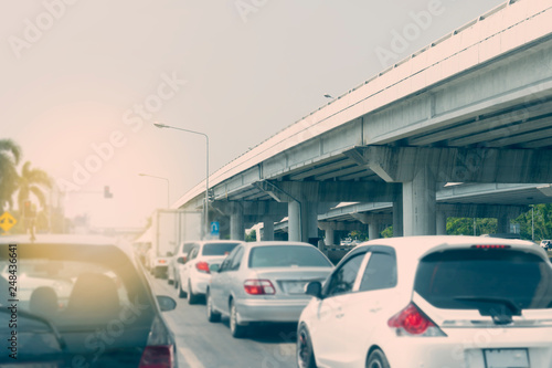 Blurred images of motor vehicle traffic on roads that focus on images from different levels of bridges along the way in daylight, rush hour.