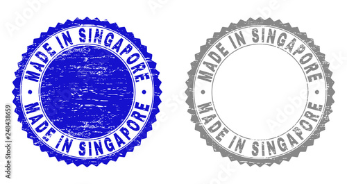 Grunge MADE IN SINGAPORE stamp seals isolated on a white background. Rosette seals with grunge texture in blue and grey colors.