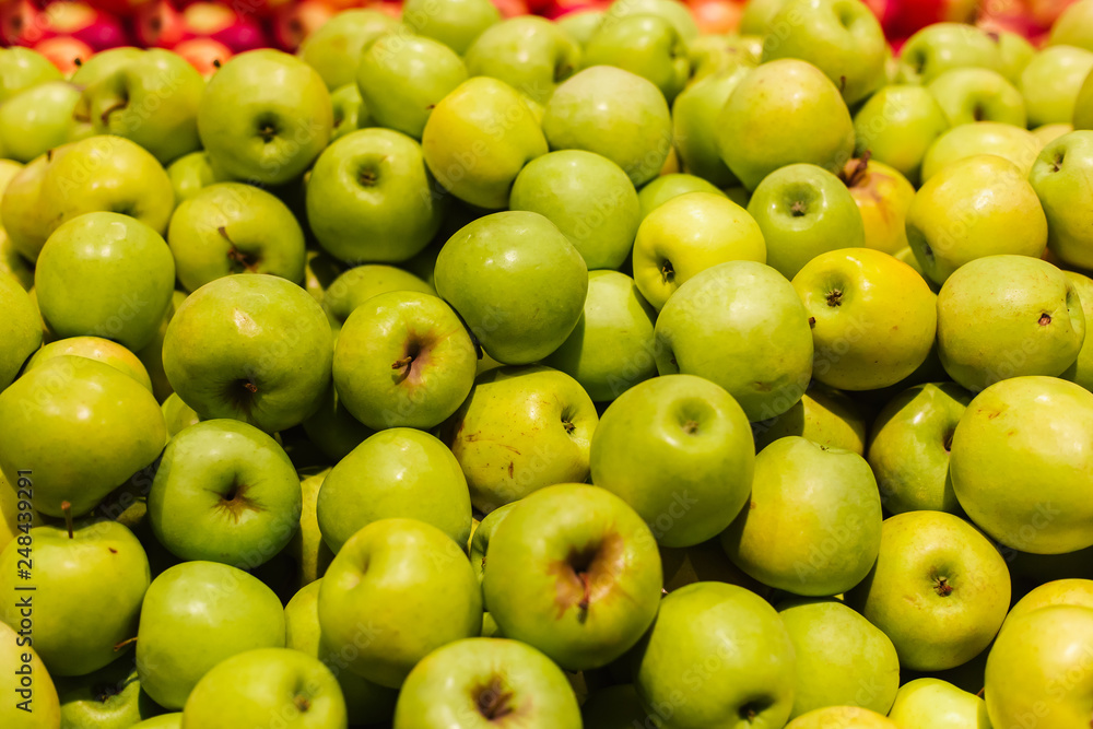 Green apples on a display in a supermarket in bulk Green apples on a display in a supermarket in bulk