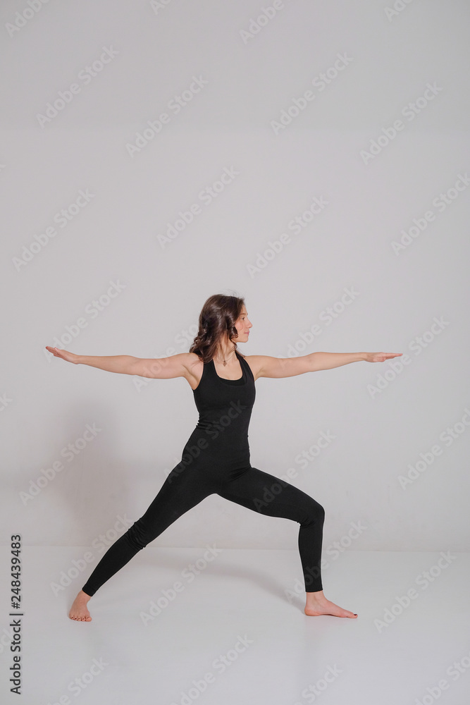 Woman practicing and stretching in a yoga studio. Basic yoga pose.