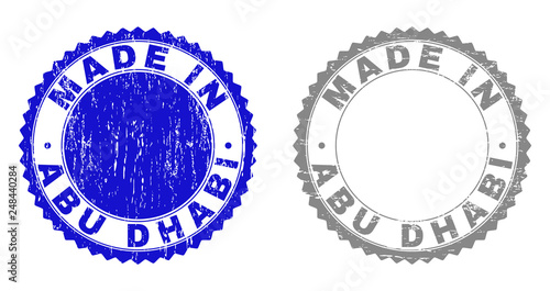 Grunge MADE IN ABU DHABI stamp seals isolated on a white background. Rosette seals with distress texture in blue and grey colors.