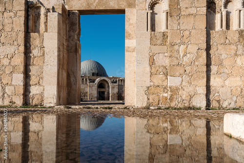 Ancient architecture with reflection on the water at Citadel in Amman, Jordan