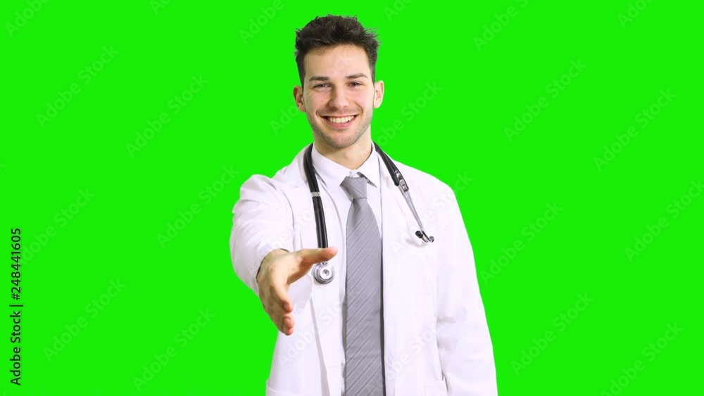 Portrait of a smiling handsome doctor giving a handshake isolated on green screen chroma key Portrait of a smiling handsome doctor giving a handshake isolated on green screen chroma key