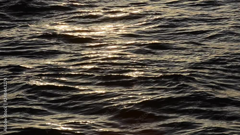 Flowing Dark Blue Waves With Reflection of Setting Sun Flowing Dark Blue Waves With Reflection of Setting Sun