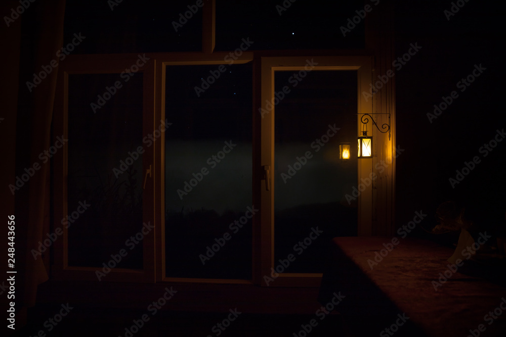 Night scene of stars seen through the window from dark room. Night sky inside dark room. Long exposure shot Night scene of stars seen through the window from dark room. Night sky inside dark room. Long exposure shot