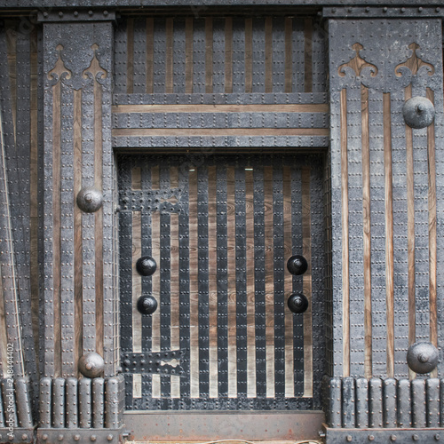 Brown vintage abstract background with detail of Japanese traditional wooden gates with metal hinges, stripes and rivets in Kanazawa, Japan.