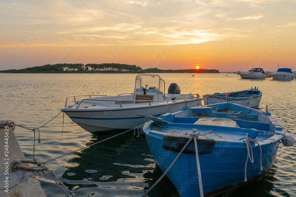 The boats and the sunset in Porto Cesario, Puglia, Italy