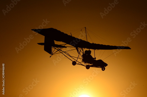 Ultralight airplane at sunset.