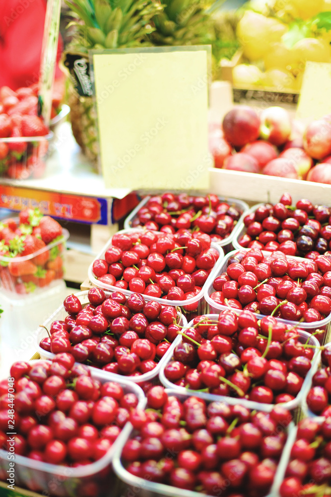 cherries in boxes on the market counter