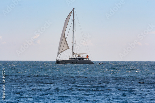 Yacht with a boat in tow.