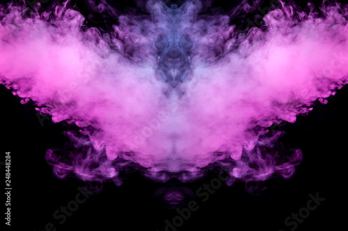 Abstract mystical bat silhouette straightened wings from streams of colorful smoke evaporating from a vape illuminated by neon lights on a black background.