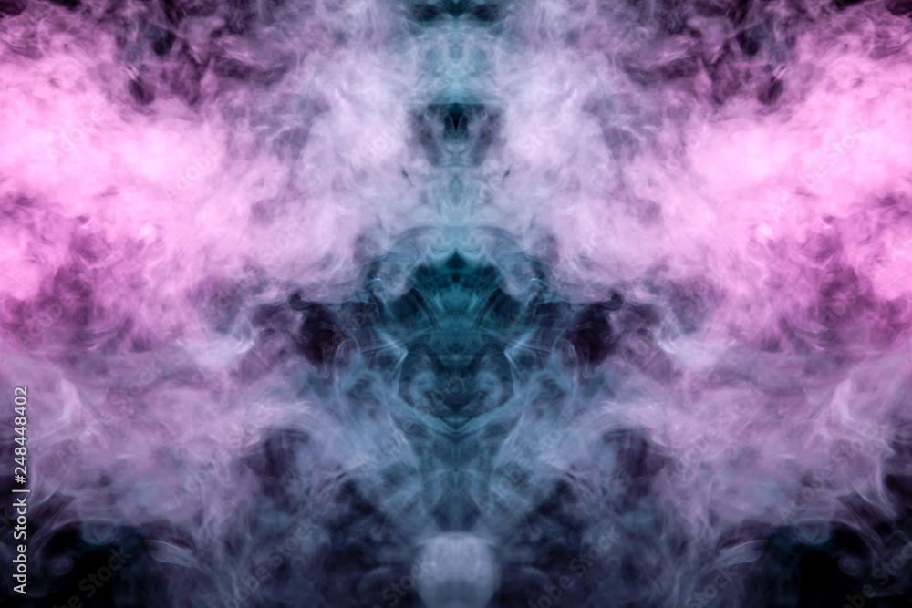 A multi-colored pattern of purple and blue smoke of a mystical shape in the form of a ghost's head or a strange creature on a black isolated background. Abstract pattern in of waves and steam. A multi-colored pattern of purple and blue smoke of a mystical shape in the form of a ghost's head or a strange creature on a black isolated background. Abstract pattern in of waves and steam.