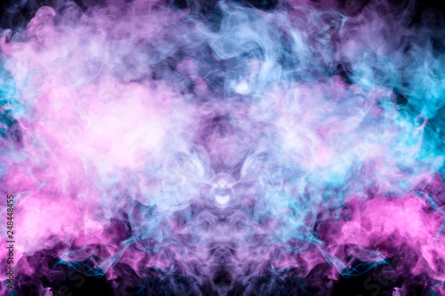 Beautiful pattern of smoke on a black background from the evaporating waves in the neon light of pink blue and purple as sea pebbles in the foam for T-shirt.