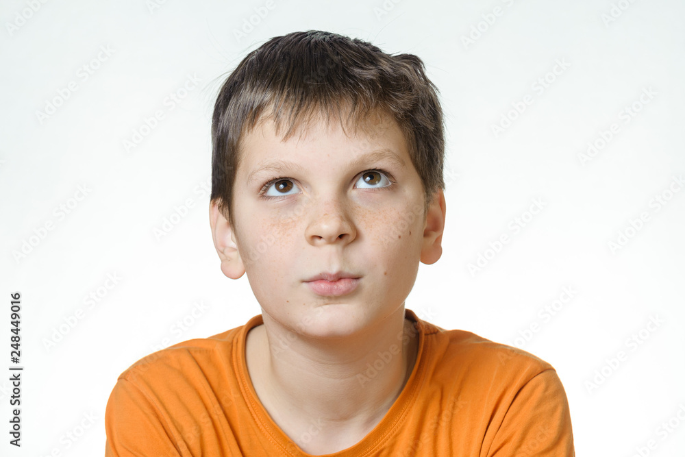 Portrait of a boy - a teenager on a white background, close-up, emotion, calm smile, thoughtfulness Portrait of a boy - a teenager on a white background, close-up, emotion, calm smile, thoughtfulness