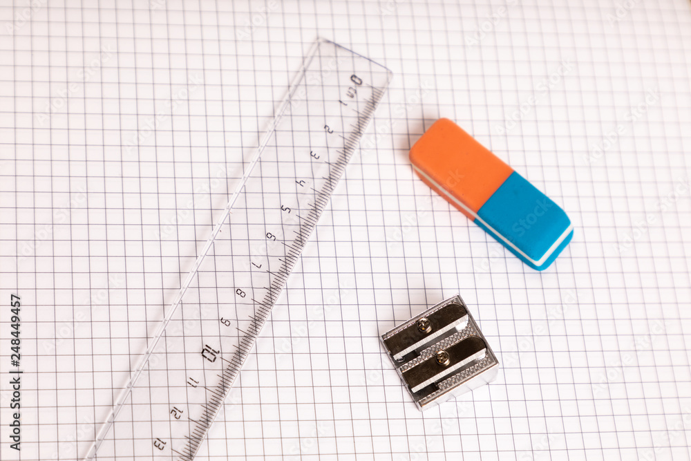 Fototapeta premium school equipment ruler, eraser with checkered paper