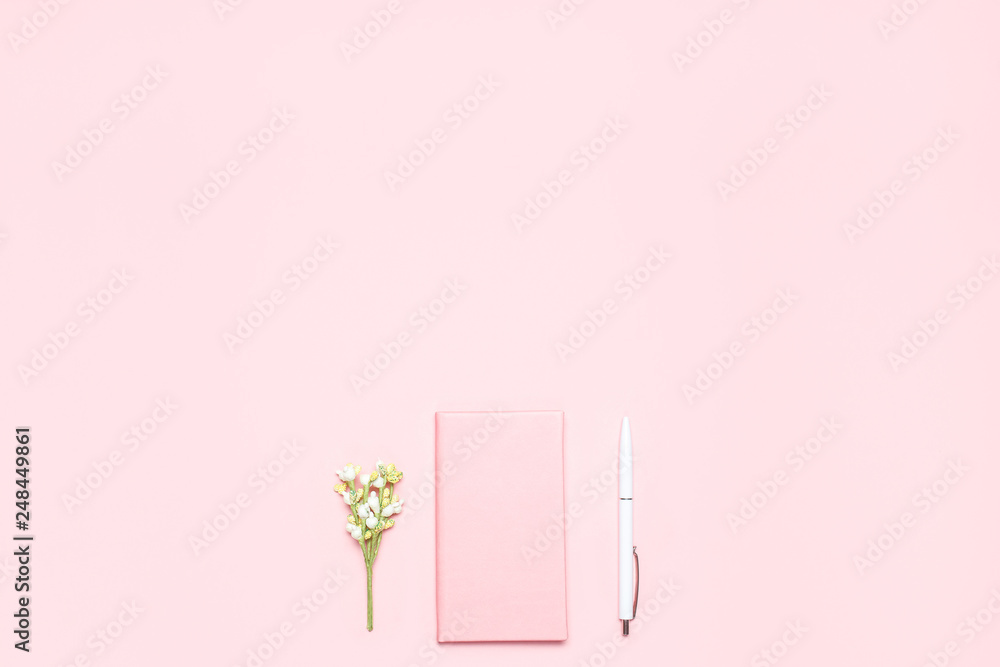 Pink diary,white pen and blooming sprig on pink desk. Minimalistic flat lay composition with copy space for bloggers, designers, magazines etc. Pink diary,white pen and blooming sprig on pink desk. Minimalistic flat lay composition with copy space for bloggers, designers, magazines etc.