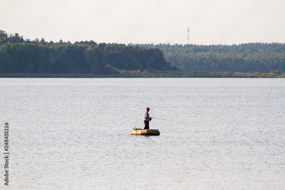 A fisherman with a fishing rod on a boat