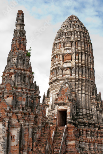 An old temple built of brown brick is a beautiful architecture with sky and clouds. © mangkla