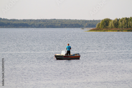 A fisherman with a fishing rod on a boat