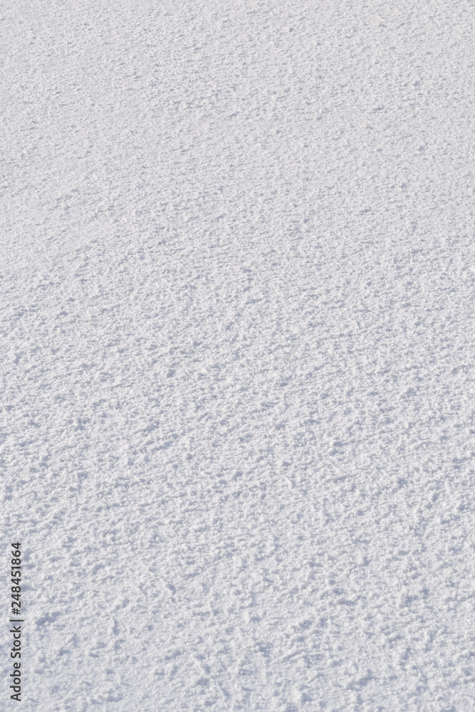 Snow surface lumps. Texture, background. Snow on a cloudy day. Vertical frame. Snow surface lumps. Texture, background. Snow on a cloudy day. Vertical frame.
