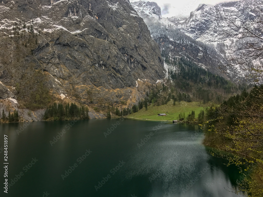 Obersee view to cloudy sky with scenic mountain wall at the background