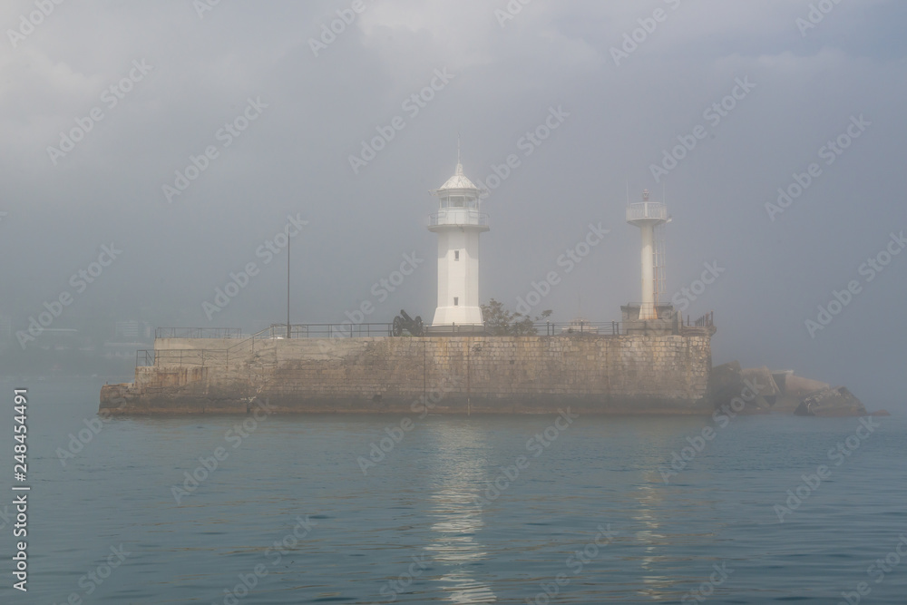 island lighthouse in the fog