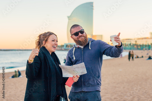 Photography Young beautiful woman asking the way from passerby - smiling and lauhging couple