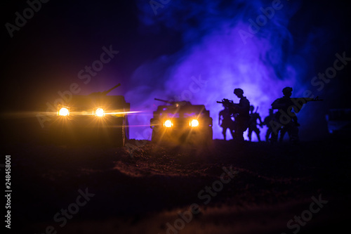 War Concept. Military silhouettes fighting scene on war fog sky background, Fighting silhouettes Below Cloudy Skyline At night. Battle scene. Army vehicle with soldiers. army