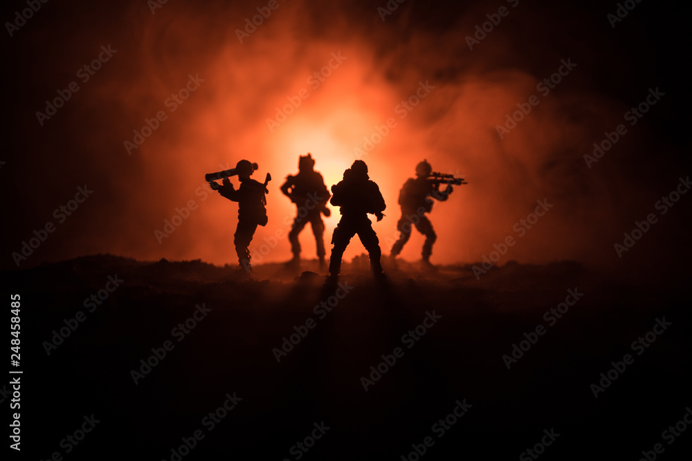Fototapeta premium Military soldier silhouette with gun. War Concept. Military silhouettes fighting scene on war fog sky background, World War Soldier Silhouette Below Cloudy Skyline At night.