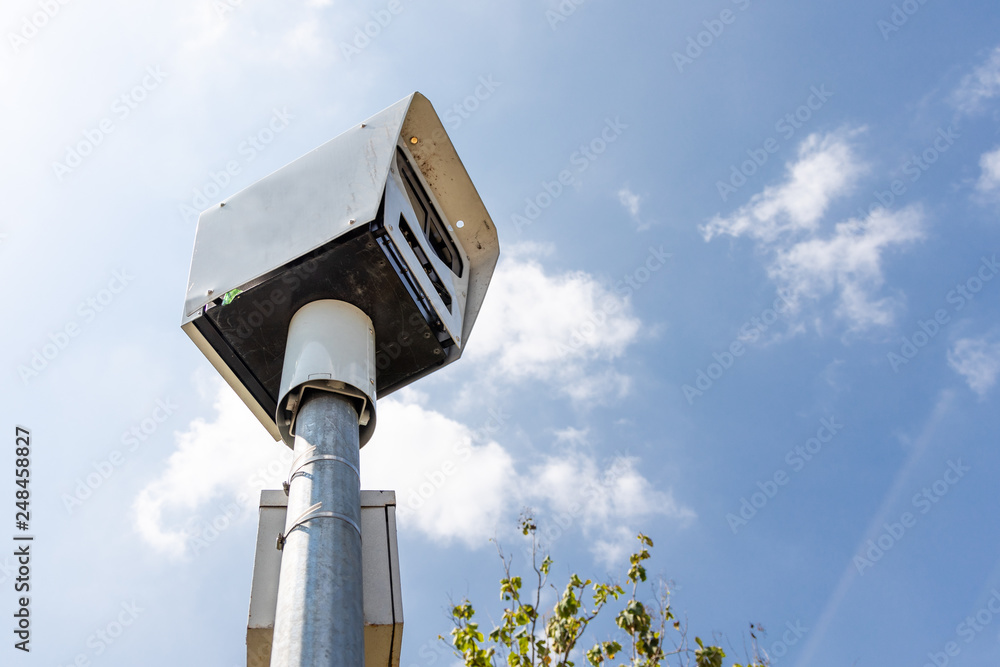 Close-up on speed trap surveillance camera along highway. Close-up on speed trap surveillance camera along highway.