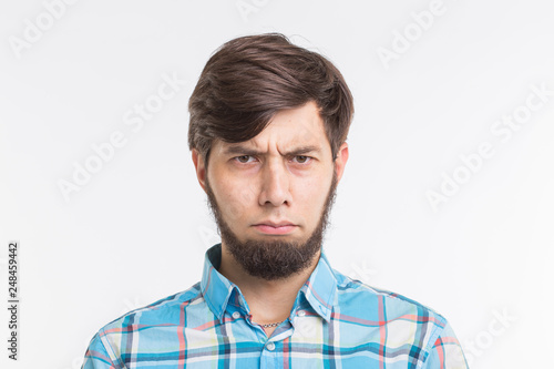 People, gesture and emotions concept - Sad or angry bearded man on white background