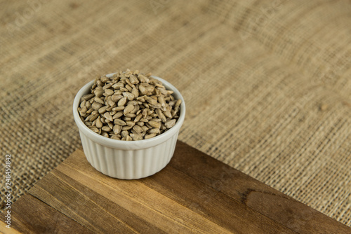 sunflower seeds in white bowl on wooden table