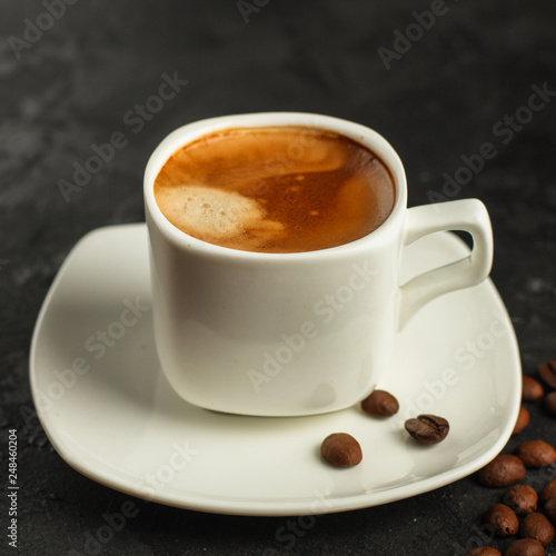 coffee fresh and hot in a white cup  aroma. serving of beverage  coffee grain . food. top view. copy space