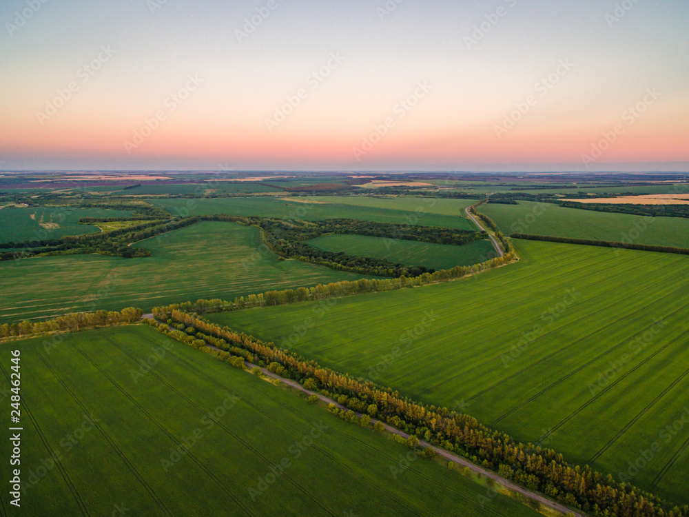 Aerial drone view, at sunset on the river among the fields. The middle band of Russia